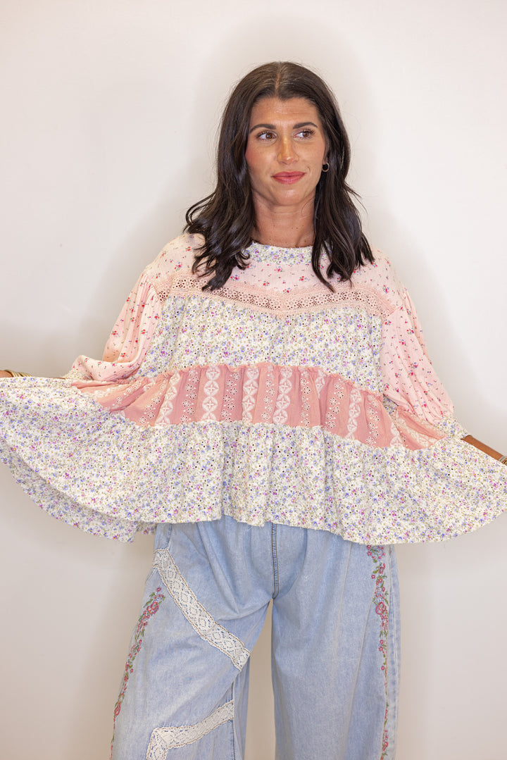 Women's pink and ivory floral patchwork top with embroidery and eyelet details by POL showing relaxed silhouette 