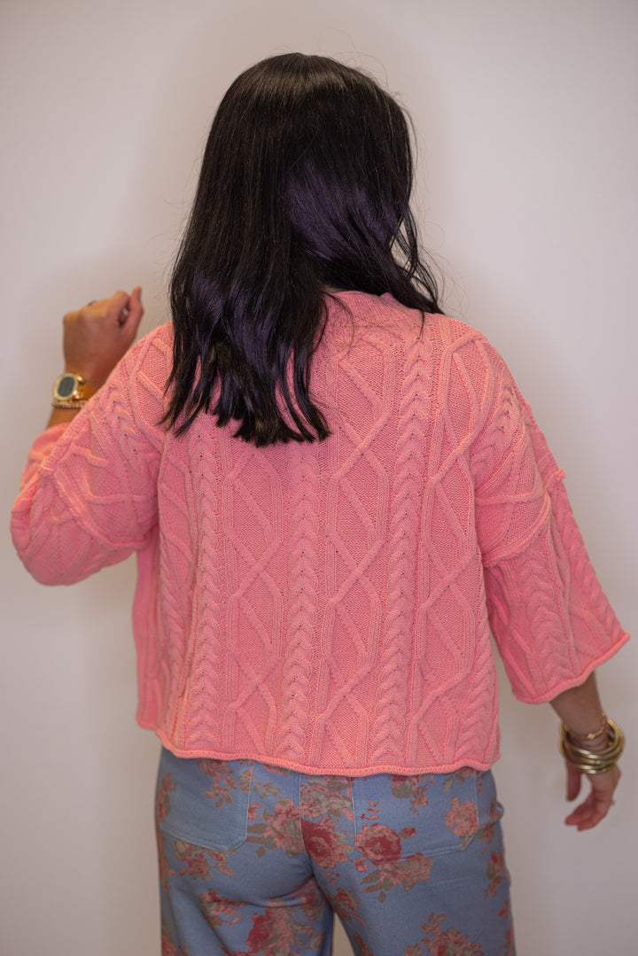 Women's coral pink cable knit cropped sweater by Entro showing up close back view