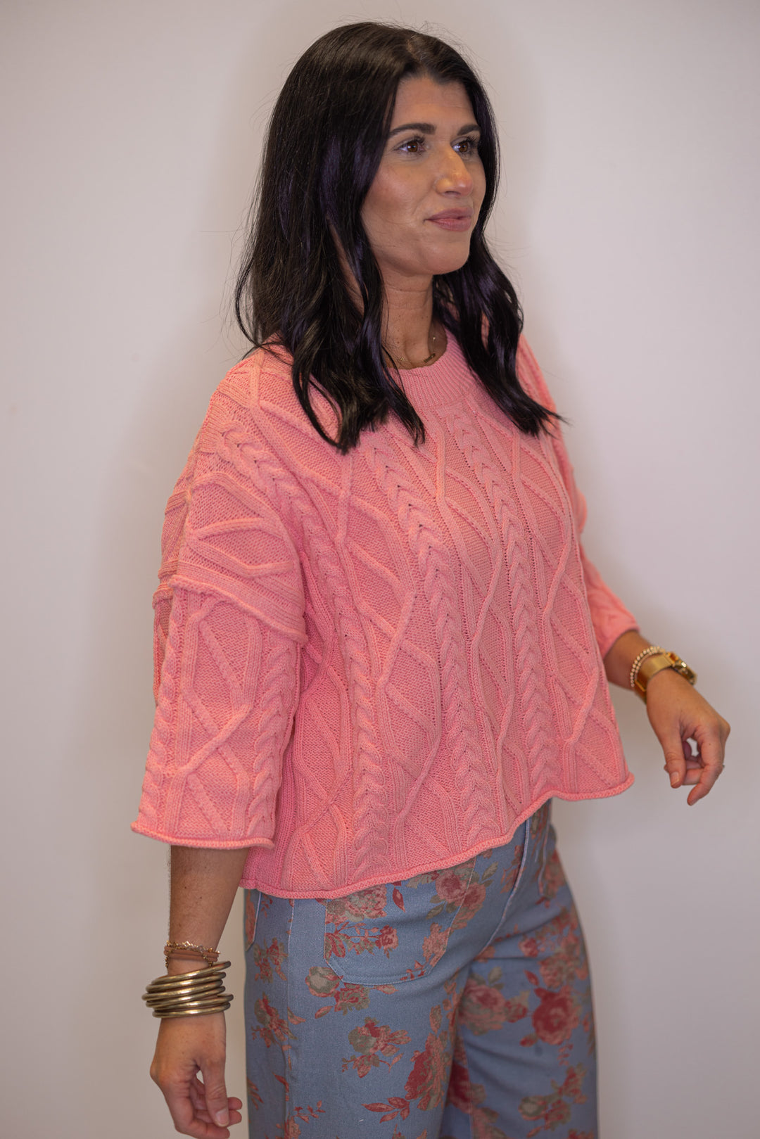 Women's coral pink cable knit cropped sweater by Entro, perfect for Spring transition outfits