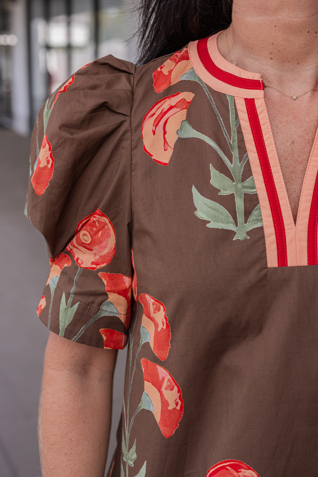 Women's brown poplin top with burgundy, peach and olive green floral print by Entro showing up close look at floral print