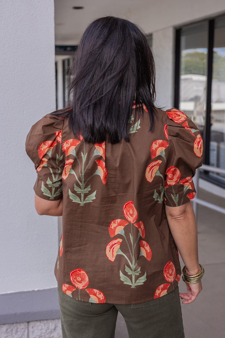 Women's brown poplin top with burgundy, peach and olive green floral print by Entro showing back view