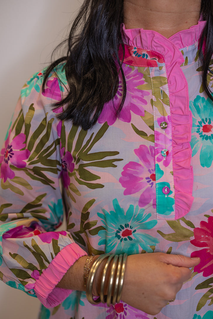 Women's pink multicolor floral print poplin dress with belted waist by Jodifl showing button front bodice with pink ruffle trim