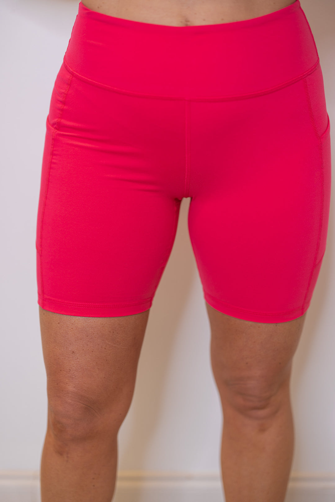 Women's flamingo pink biker shorts with side pockets, great for pickleball