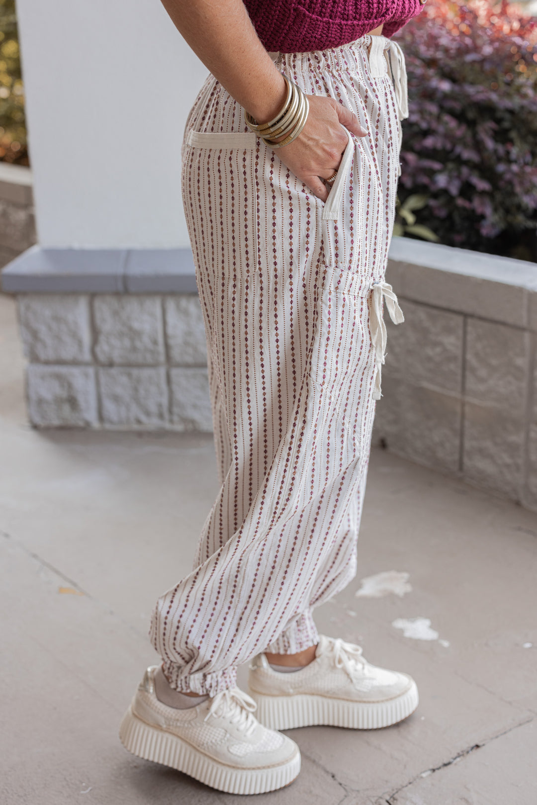 Women's oatmeal cargo jogger pants with redish brown and caramel print stripes by ee:some showing up close side view