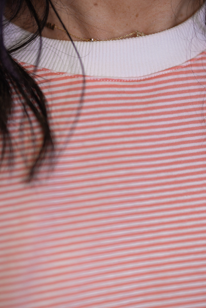 Women's coral and white striped knit oversized top by Wishlist showing close look at striped pattern