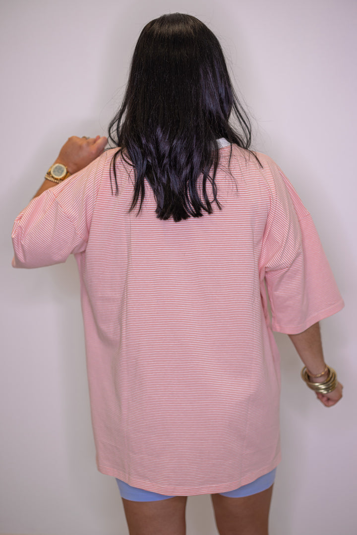 Women's coral and white striped knit oversized top by Wishlist showing up close back view