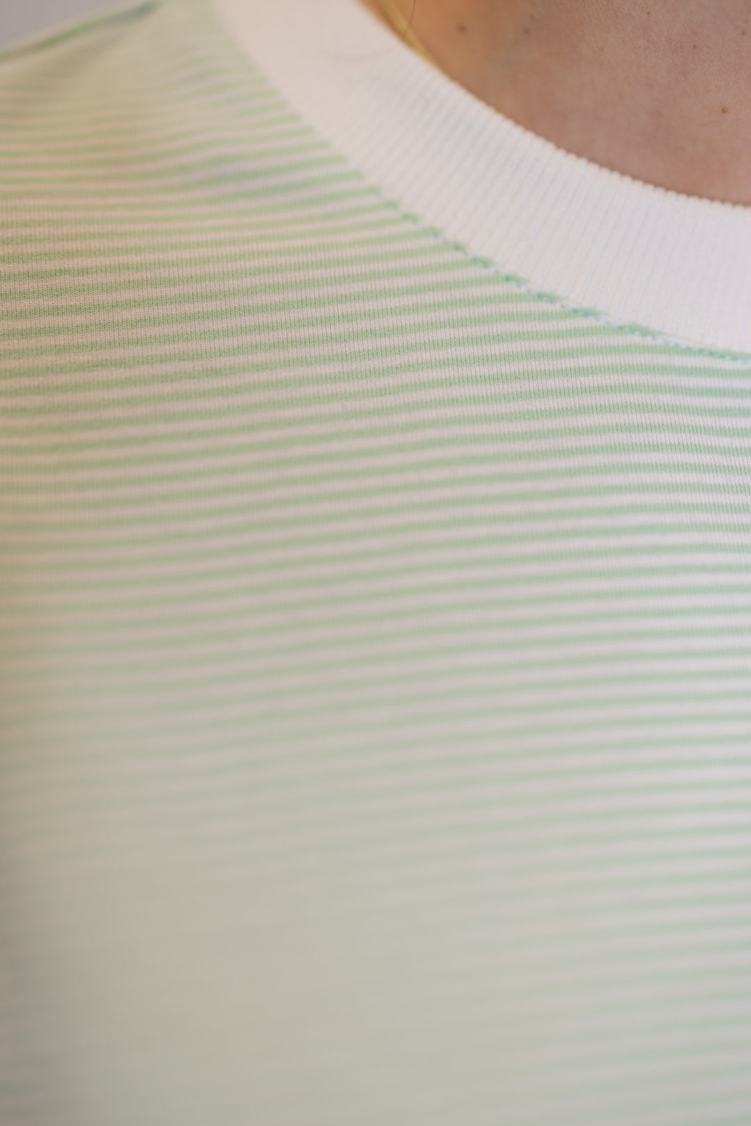 Women's mint green and white striped knit oversized top by Wishlist showing trendy striped pattern