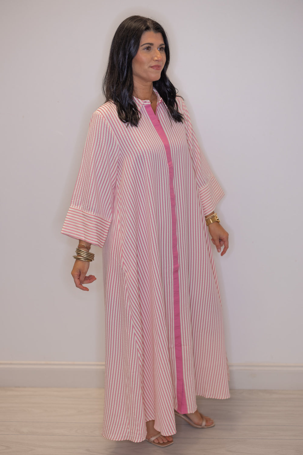 Women's striped light pink maxi dress by Entro showing flattering striped pattern