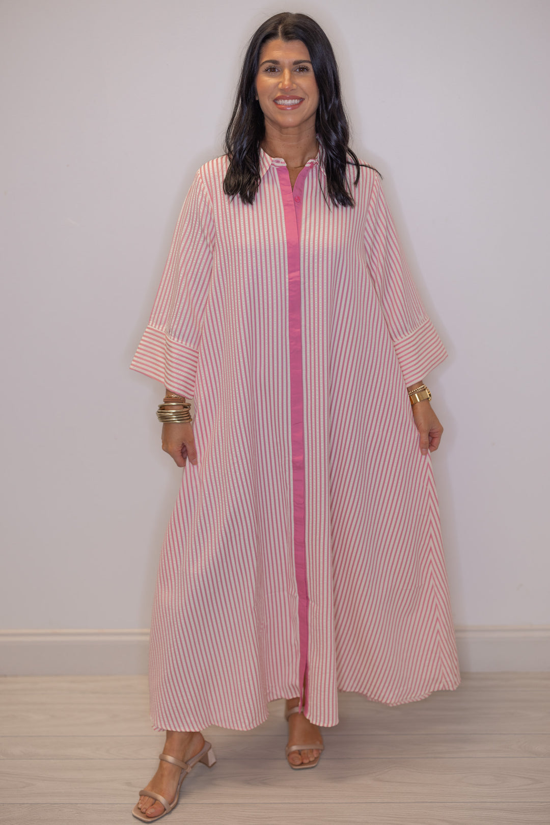 Women's striped light pink maxi dress by Entro showing flowy skirt