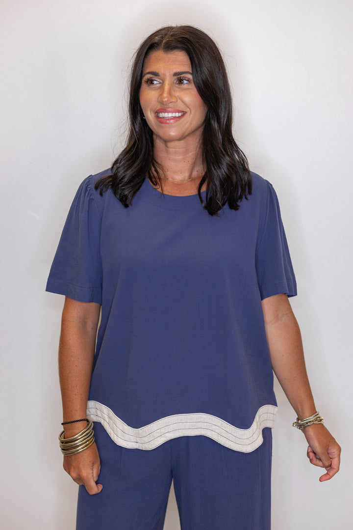 Women's linen top in medium blue color with oatmeal scalloped bottom hem by Umgee