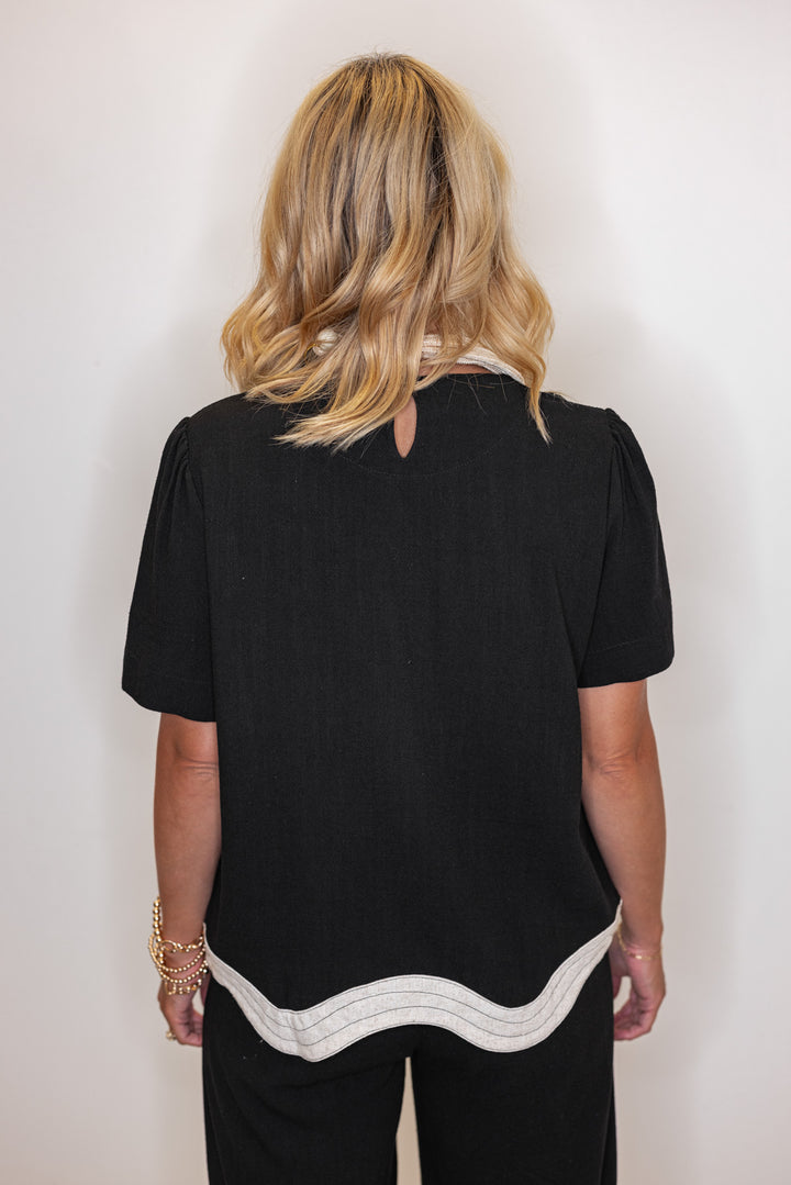 Women's linen top in black with oatmeal scalloped bottom hem by Umgee showing back view