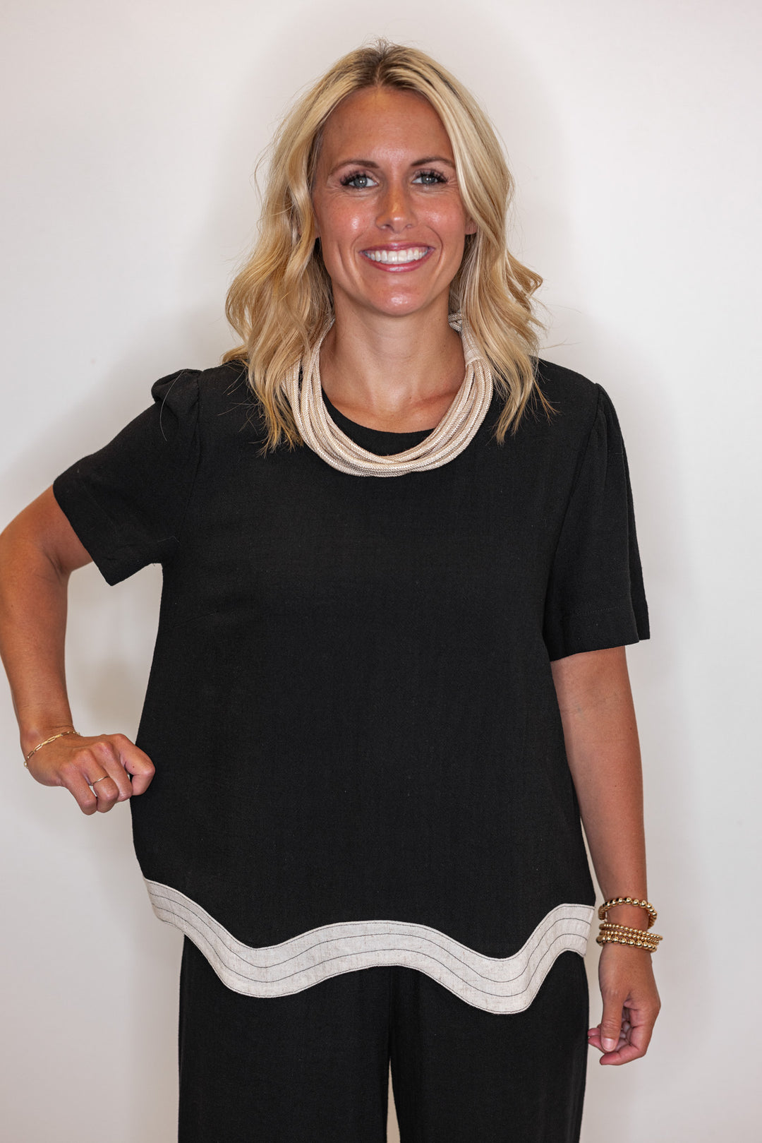 Women's linen top in black with oatmeal scalloped bottom hem by Umgee showing relaxed fit