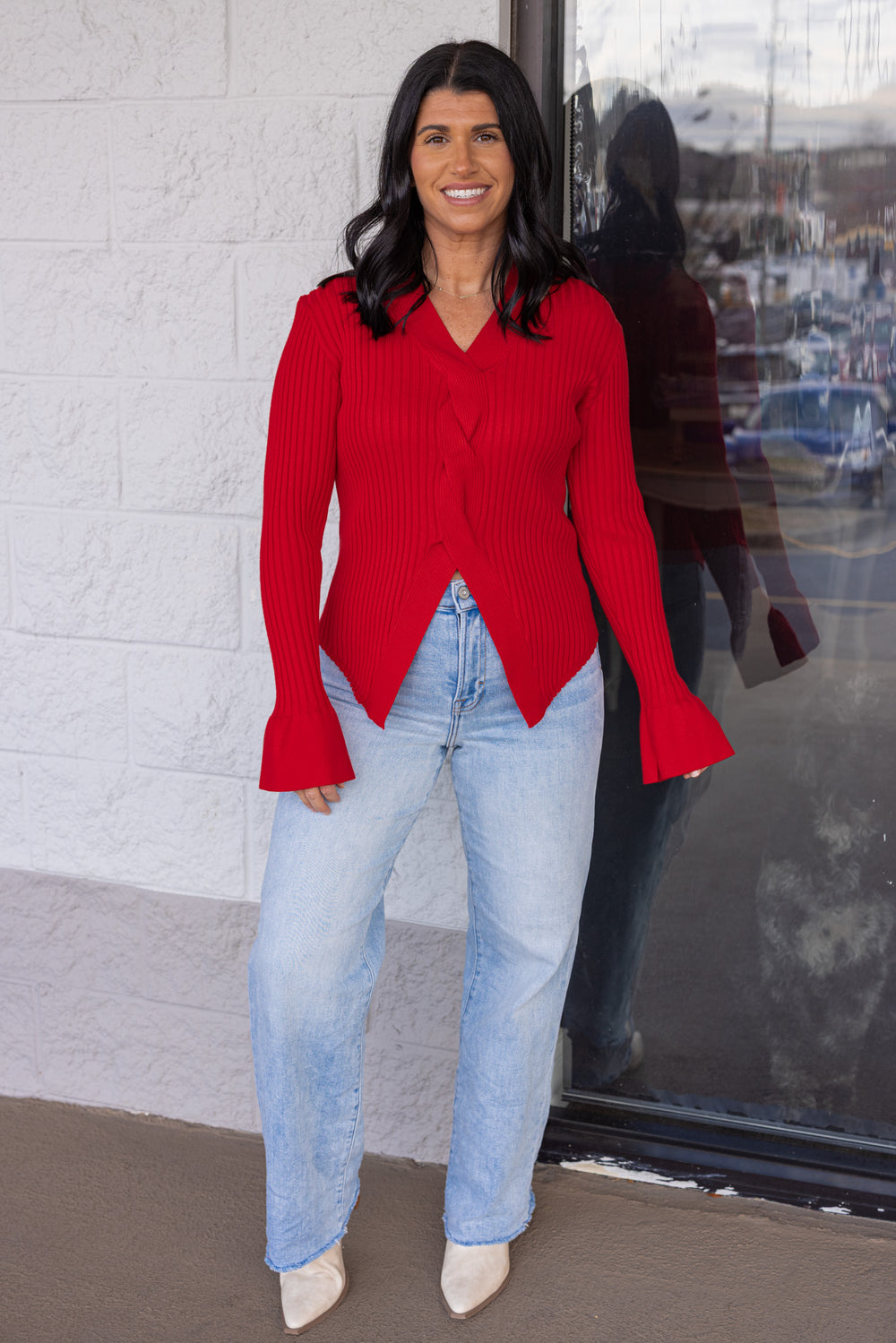 Women's red ribbed sweater knit top with a twisted front and peekaboo shoulders by So Me showing full front view