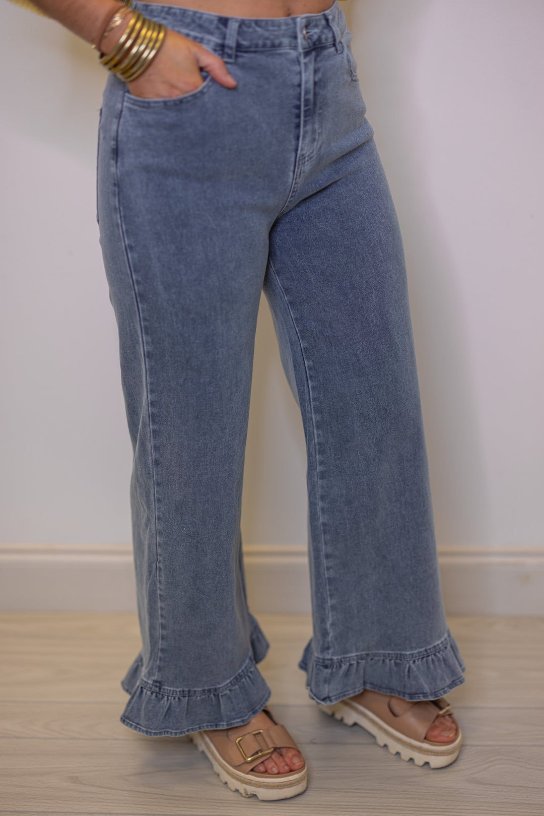 Women's light blue twill denim pants with ruffle cuffs by Entro showing wide leg fit