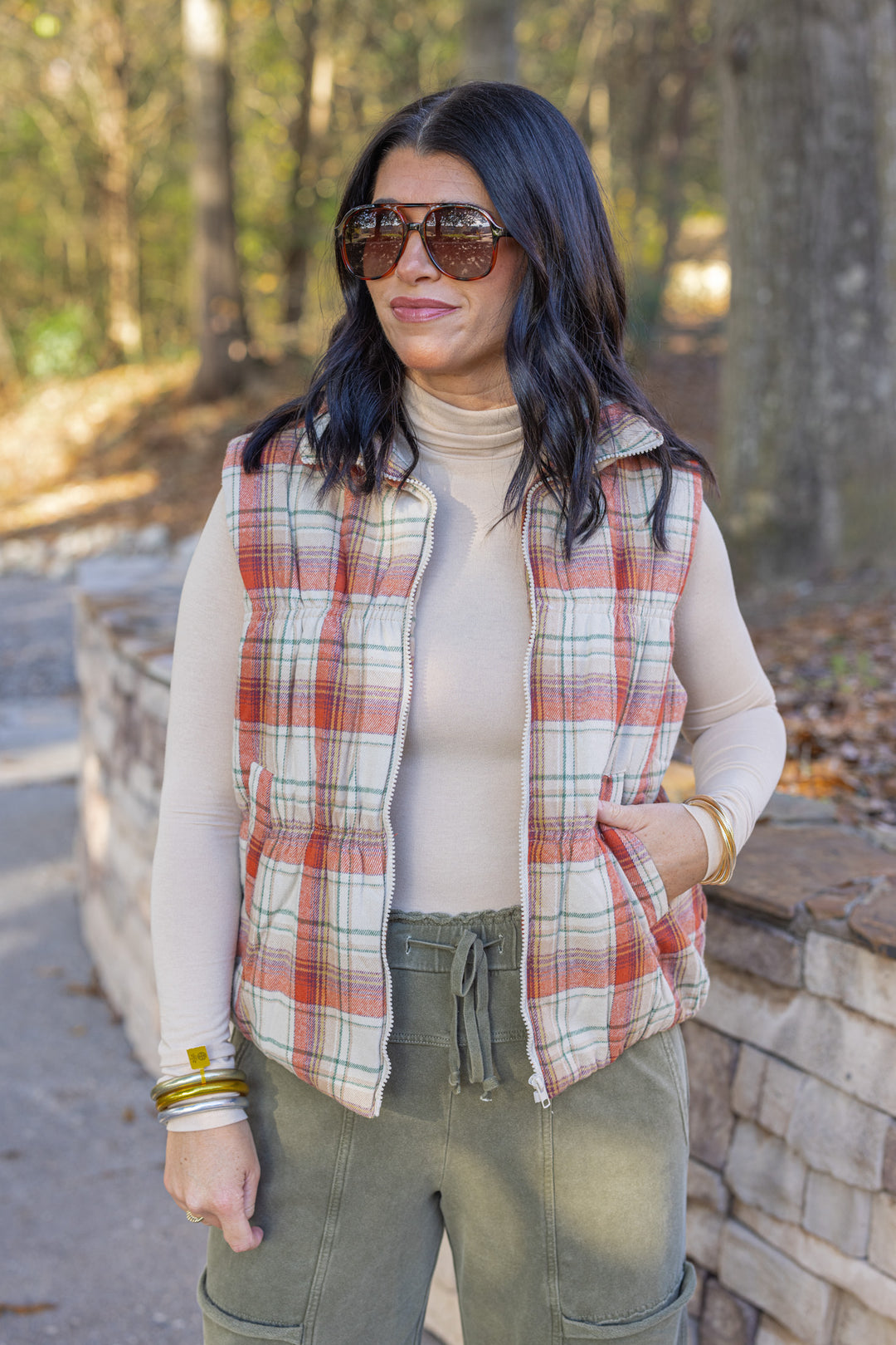 Women's quilted puffer vest in taupe, brown, persimmon orange and green plaid by Easel