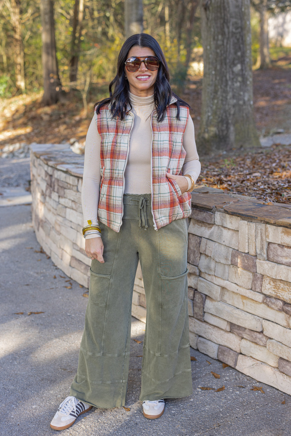 Women's quilted puffer vest in taupe, brown, persimmon orange and green plaid by Easel showing full front view