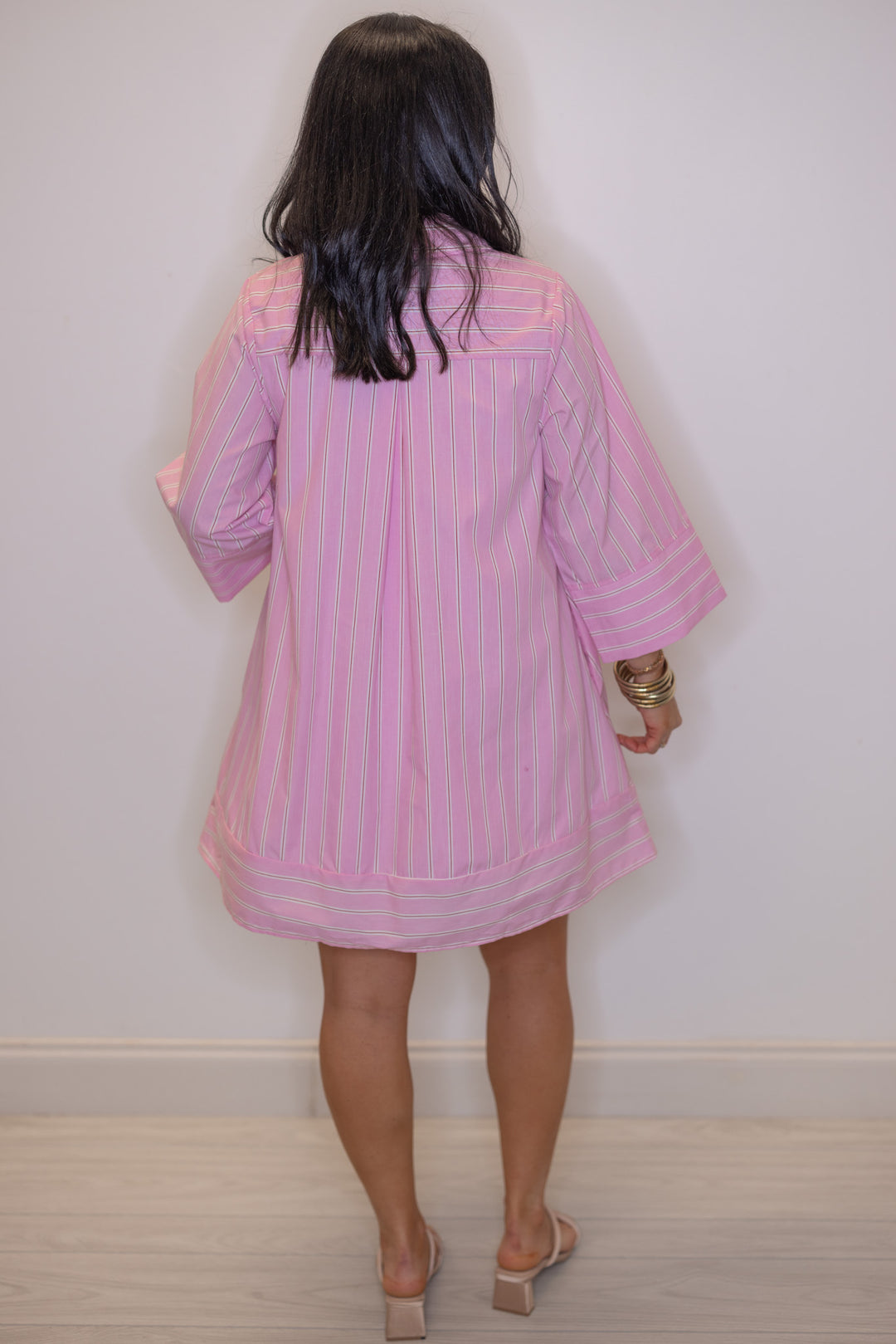 Women's pink and white striped dress with hot pink center trim by Entro showing wide sleeves