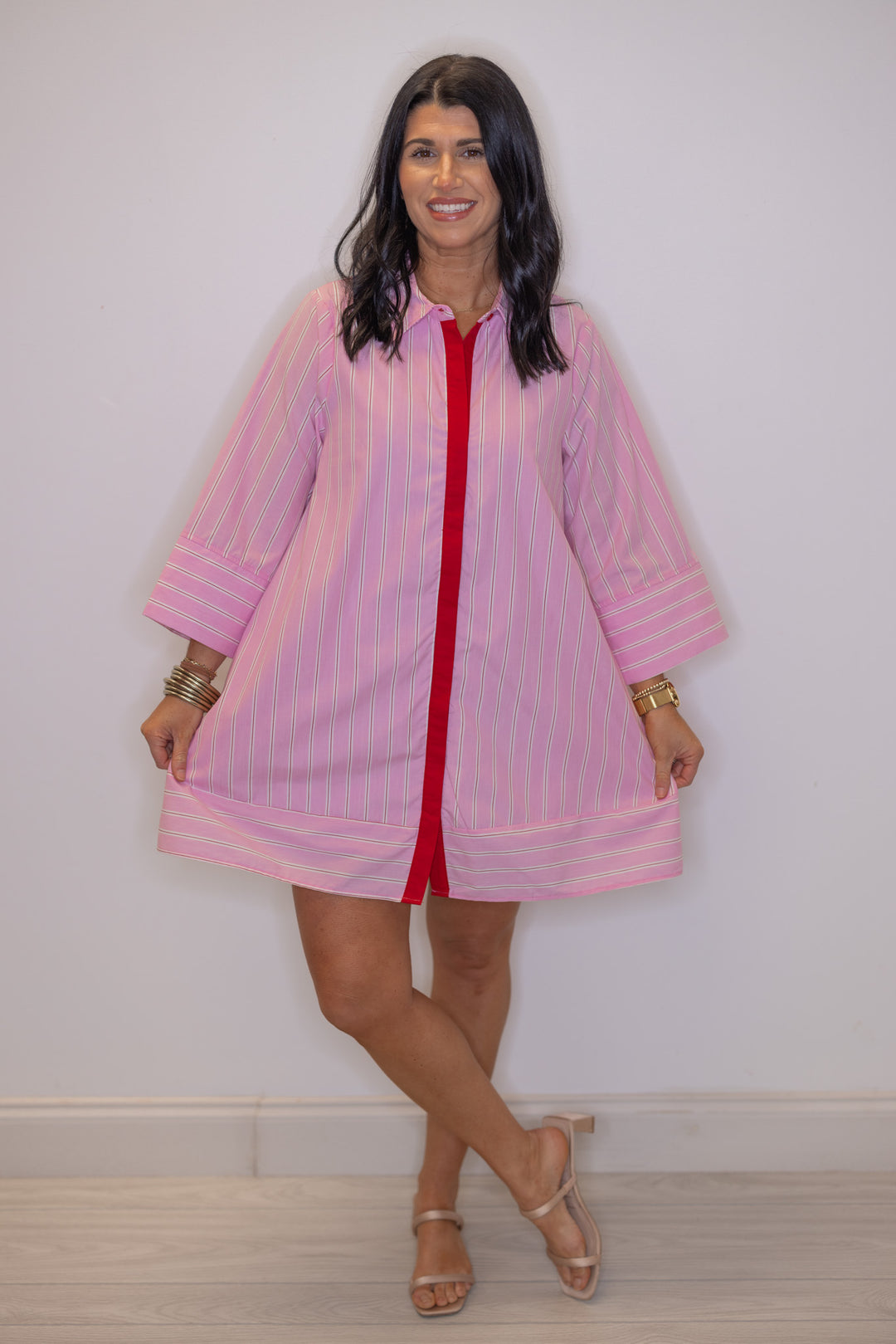 Women's pink and white striped dress by Entro showing contrasting bottom hem