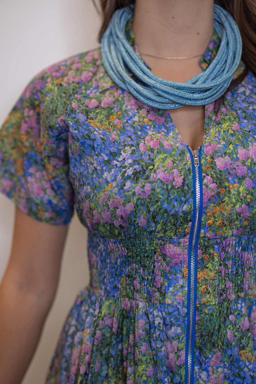 Women's blue multicolor floral midi dress by Entro showing zipper front 