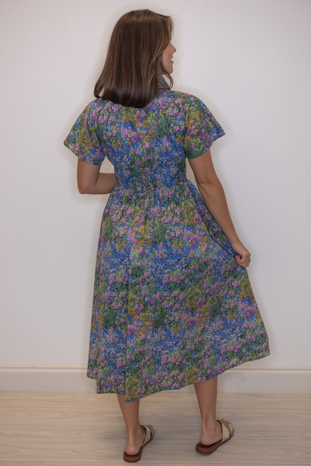 Women's blue multicolor floral midi dress by Entro showing flowy skirt