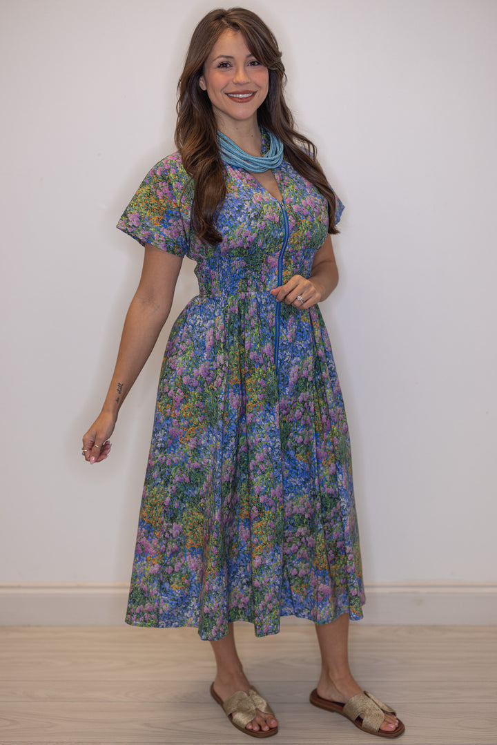 Women's blue multicolor floral midi dress by Entro showing smocked waist