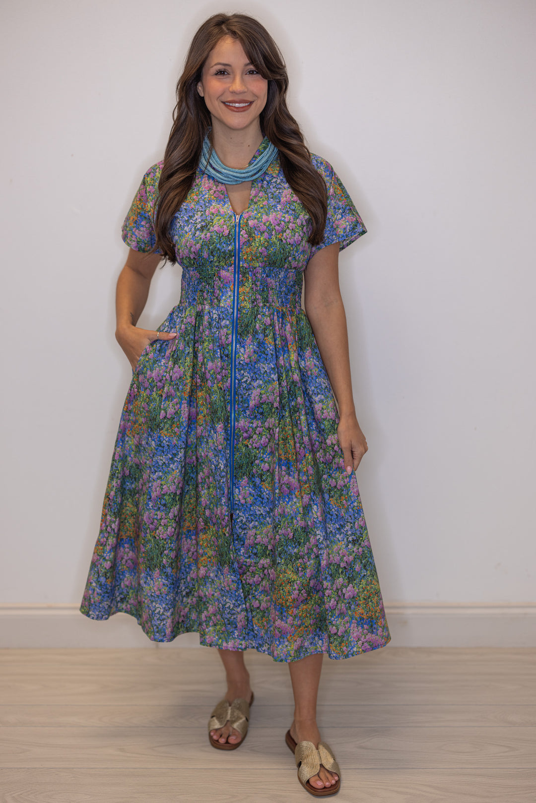 Women's blue multicolor floral midi dress with zipper front and a smocked waist by Entro