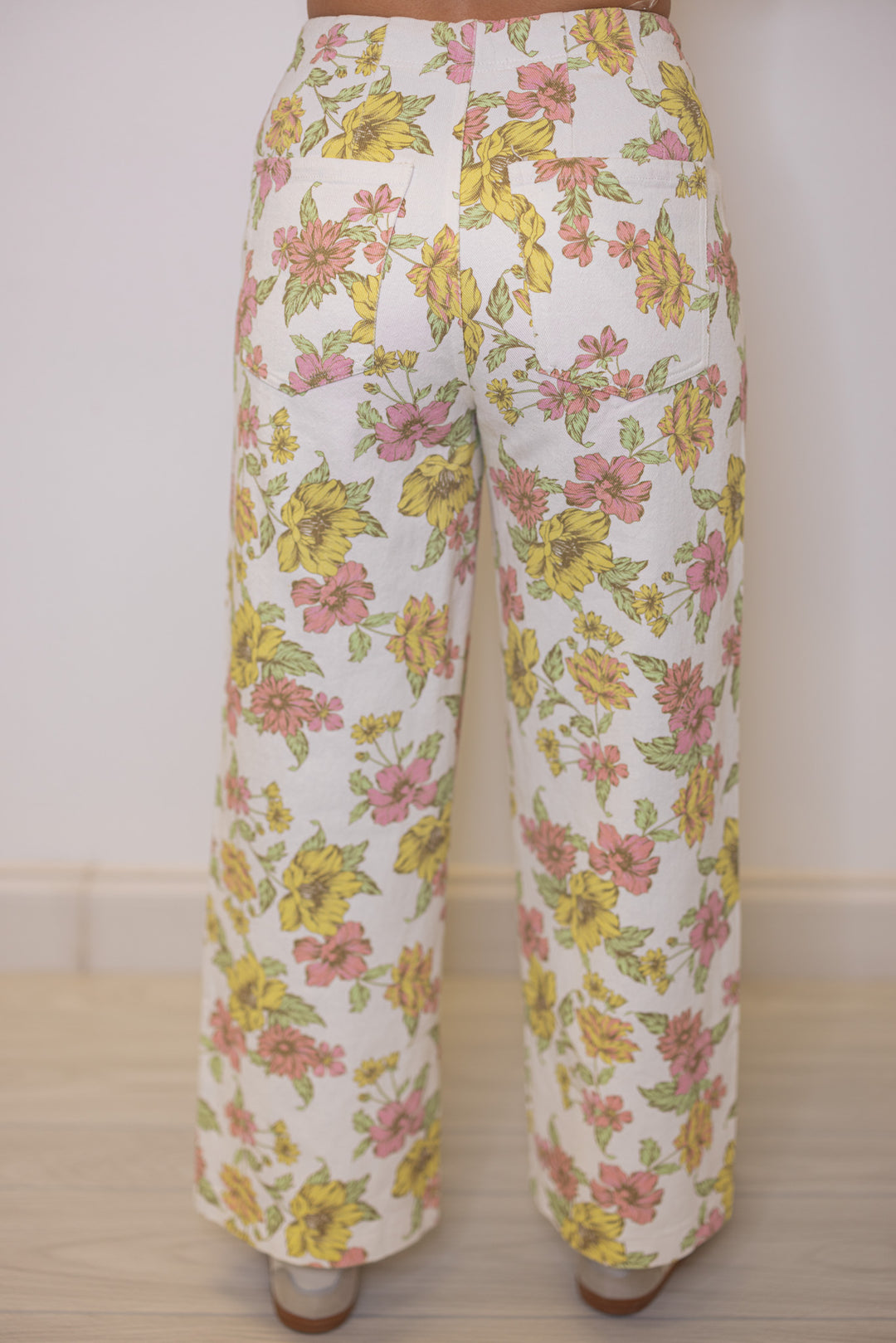 Women's cream twill denim wide leg pants in pink and yellow floral print by Entro showing up close back view