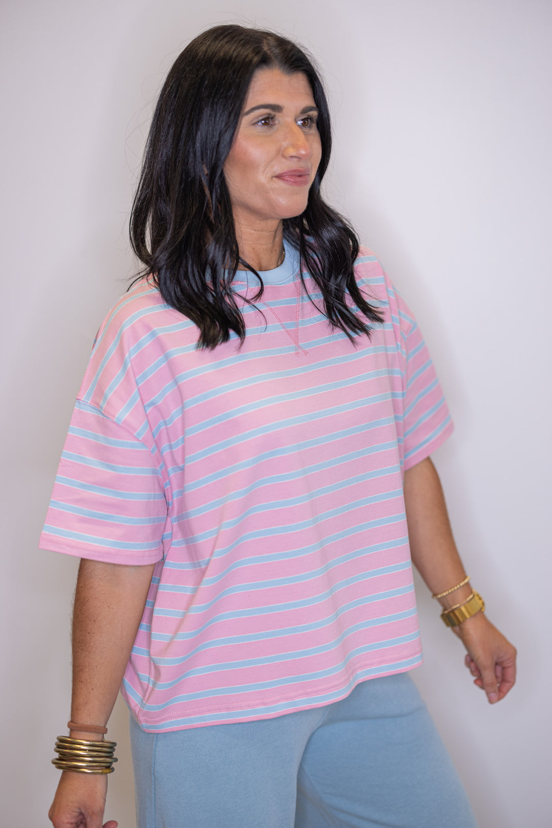 Women's pink and sky blue striped knit top by Wishlist showing up close side view