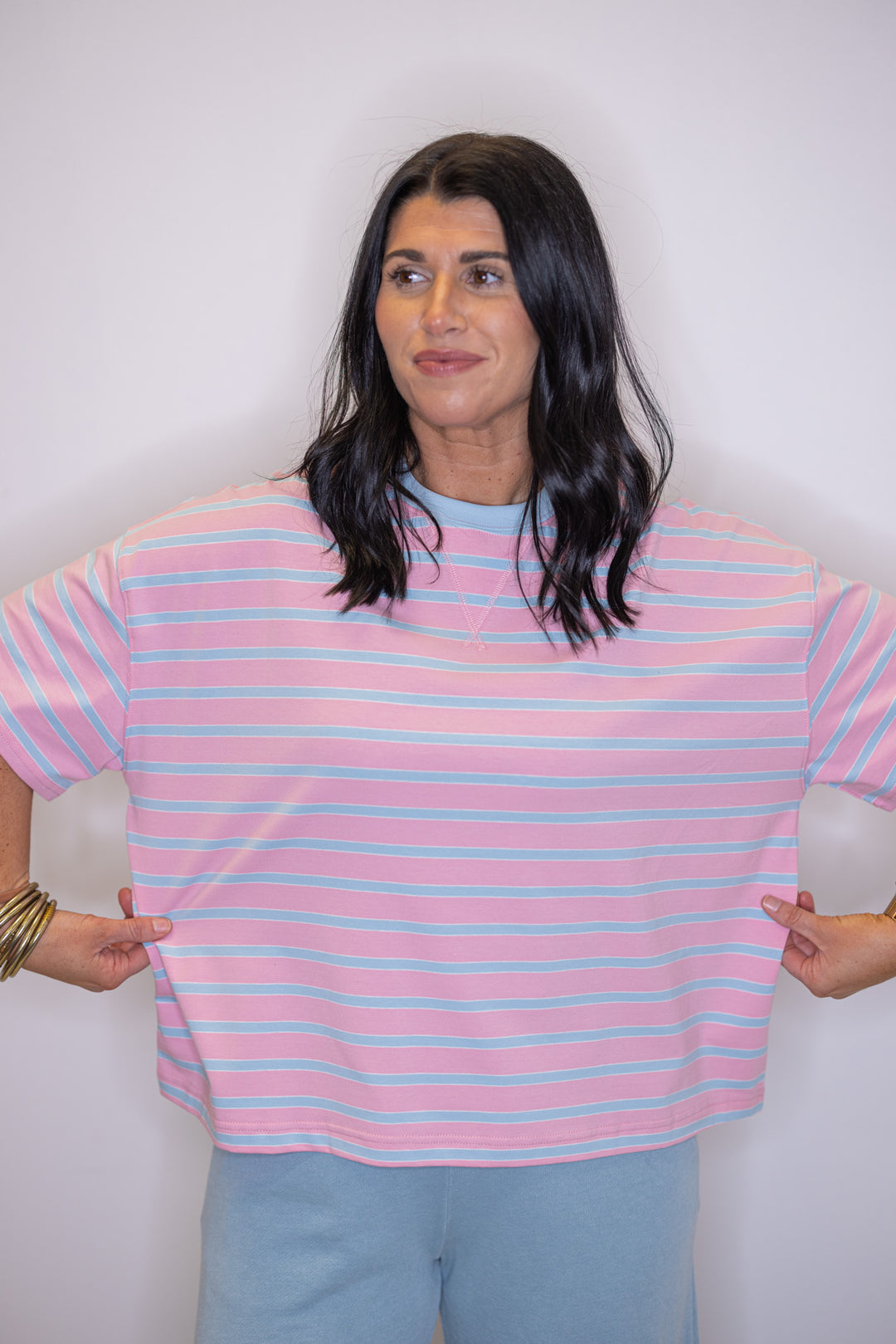Women's pink and sky blue striped knit top by Wishlist showing true to size fit