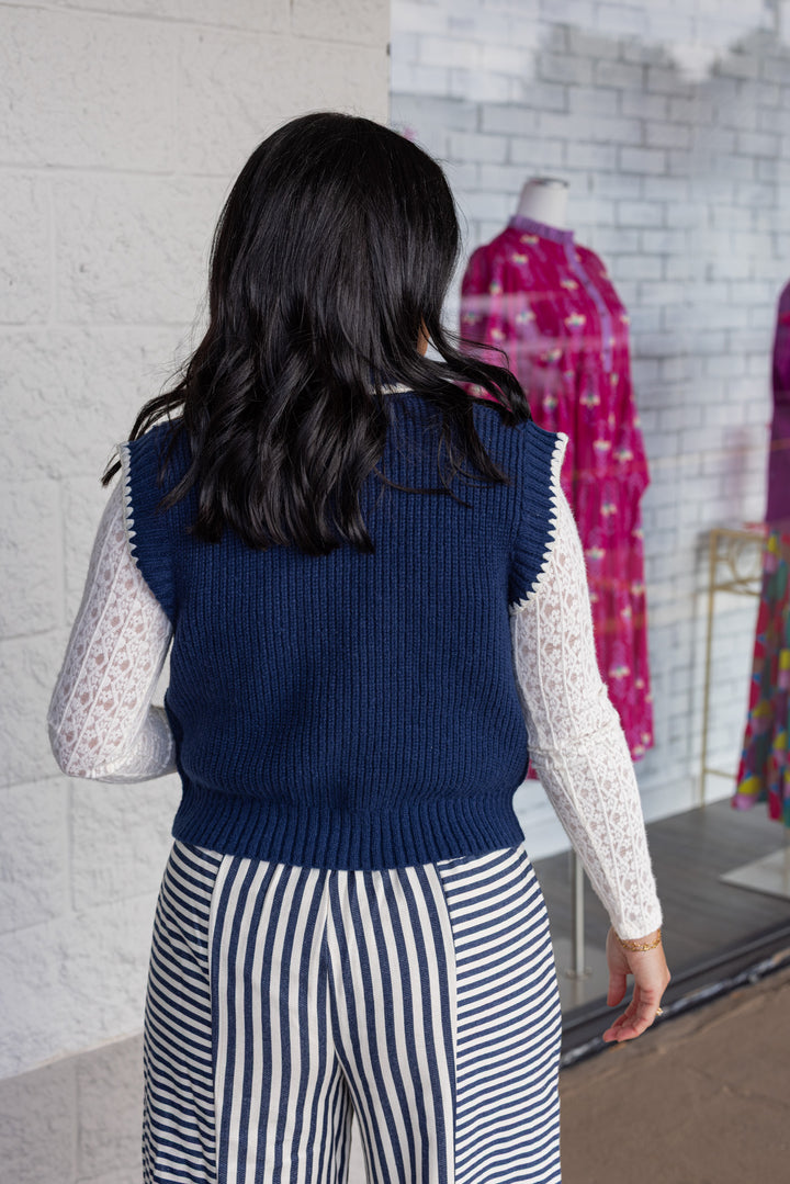 Women's navy blue knit tie neck button front sweater vest with white trim by &merci showing up close back view