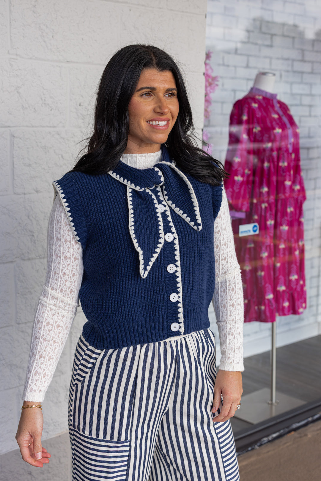Women's navy blue knit tie neck button front sweater vest with white trim by &merci showing up close, slight side view