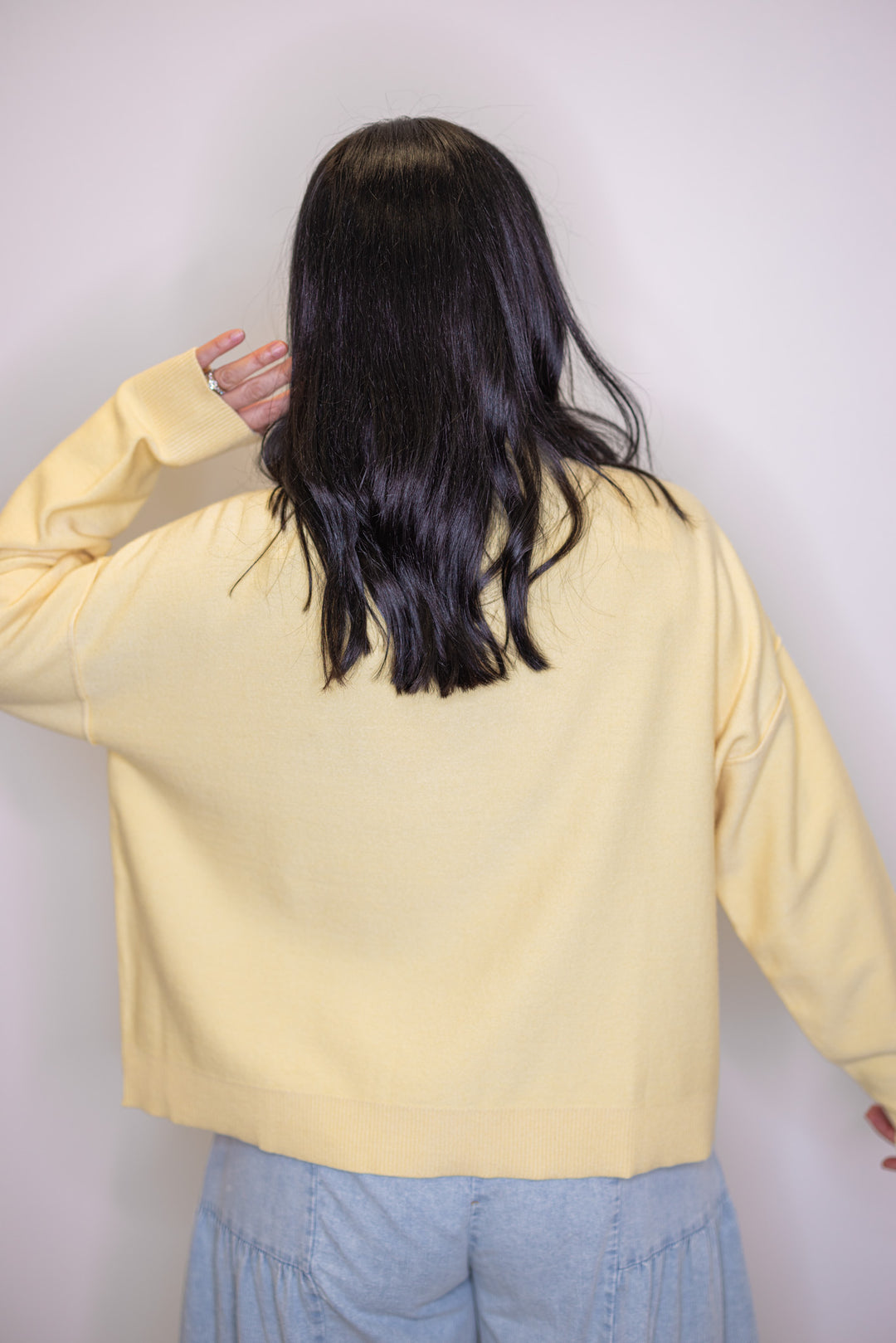 Women's butter yellow knit mock neck top by Wishlist showing up close back view