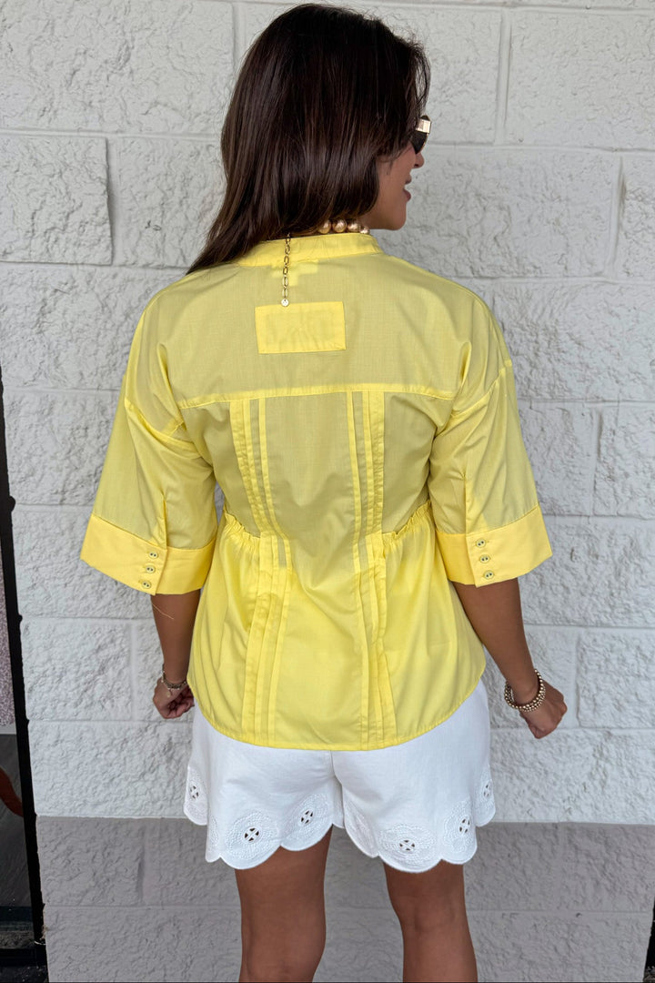 solid yellow ruched pintuck details button front short sleeve ruffle waist top