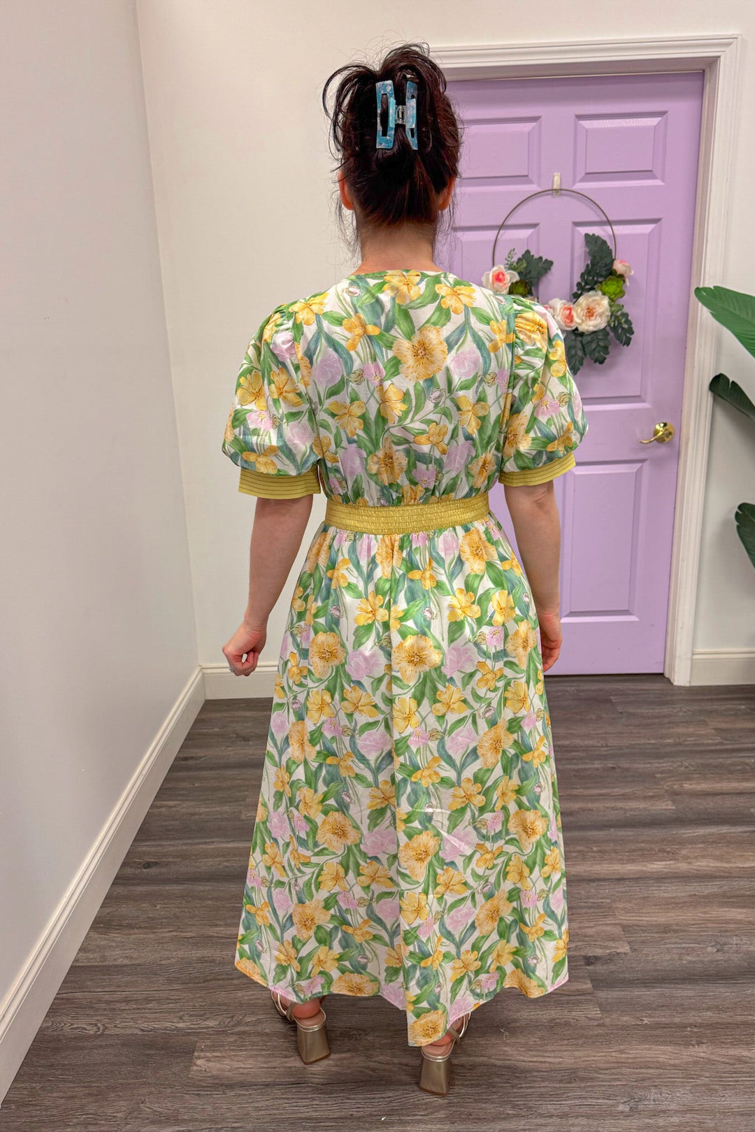 Back view of Yellow and green floral midi dress with a cinched waistband