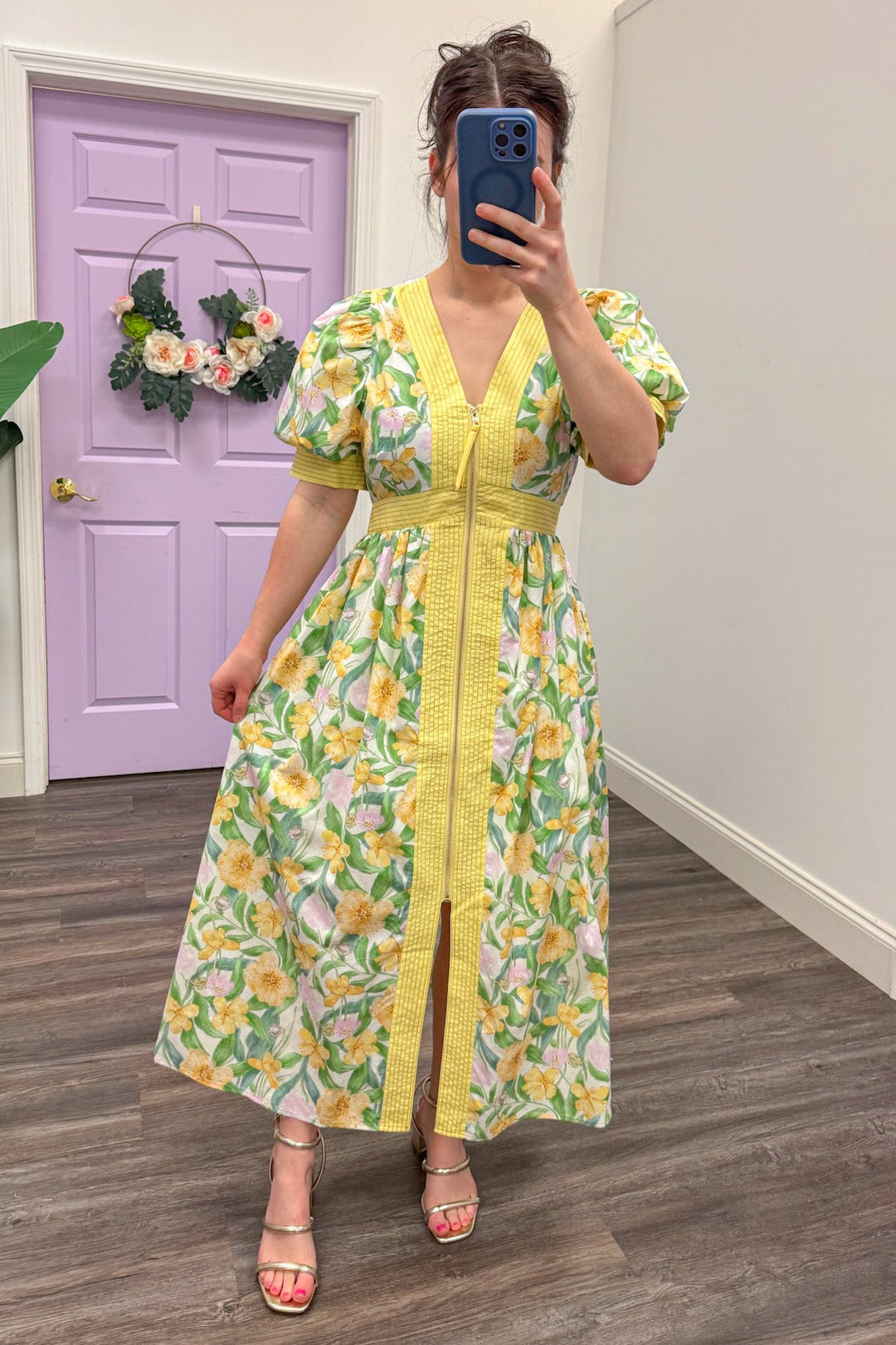Yellow and green floral midi dress paired with gold strappy sandals