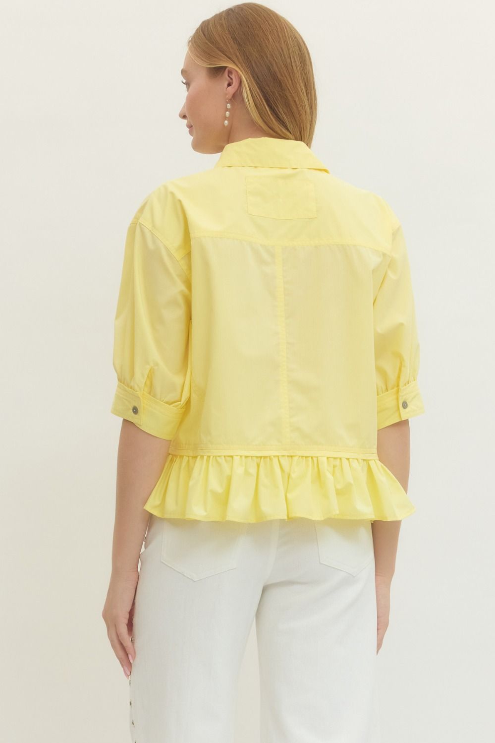 Women's semi-cropped button down yellow peplum top with ruffled hem by Entro showing back view